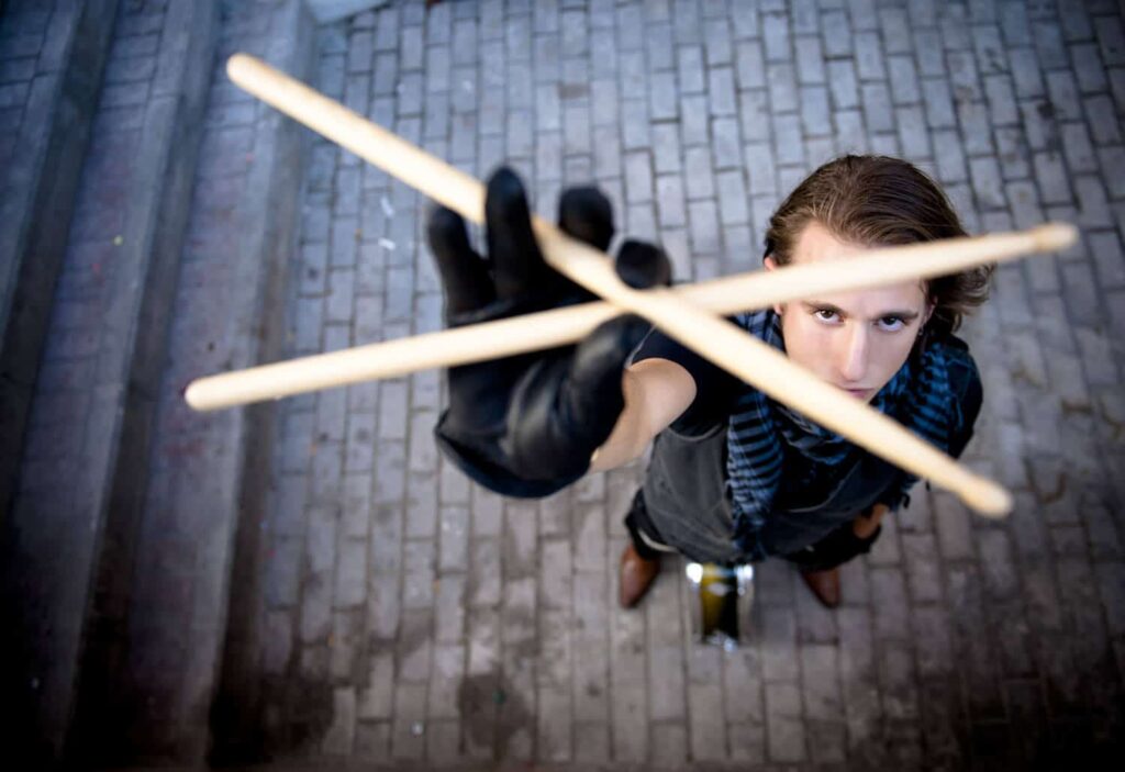 Drummer holding sticks wearing drum gloves