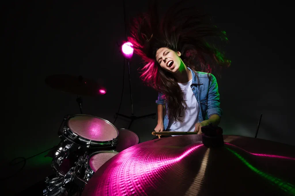 Person playing the drums intensely